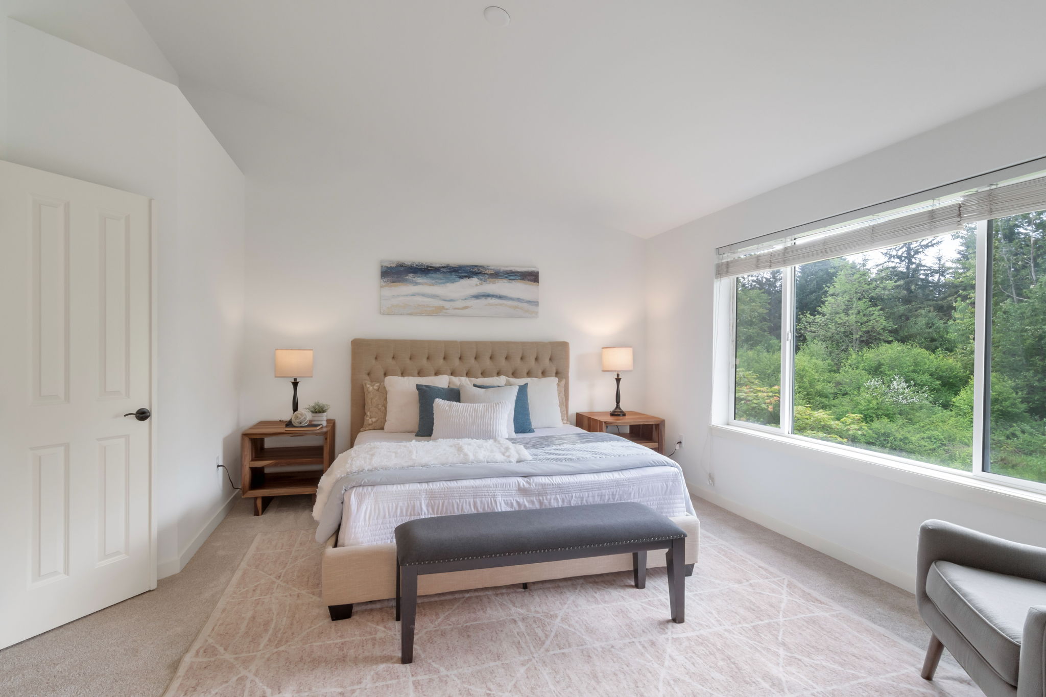 Renewed primary bedroom with new carpet and greenbelt views