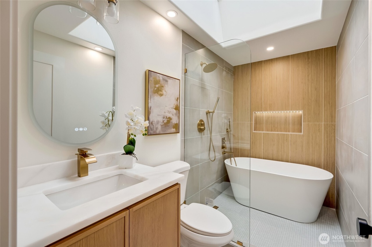 Rebuilt marble-clad bathroom with a freestanding tub
