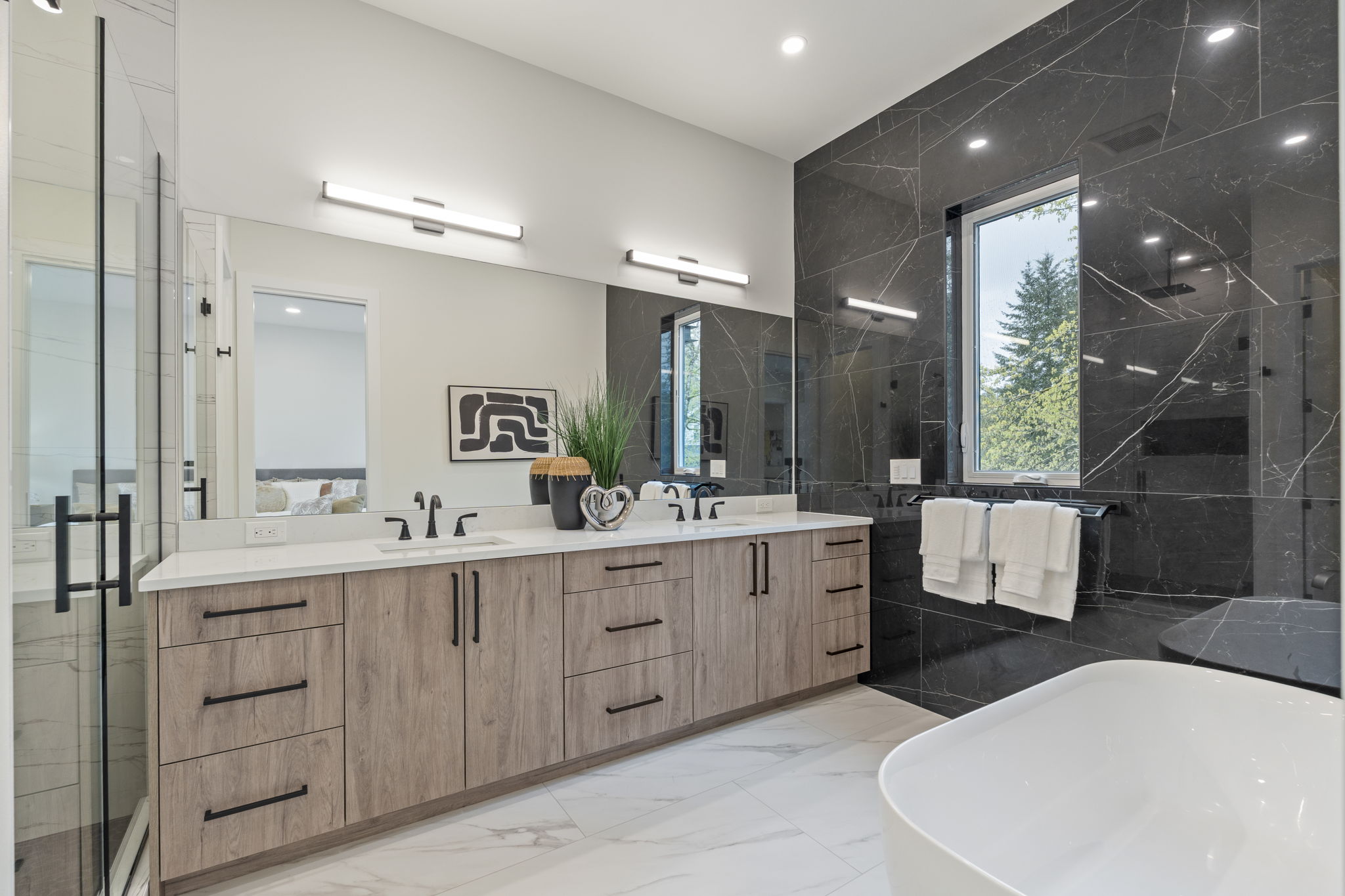Spa-style primary bath with freestanding tub and floor-to-ceiling glass shower